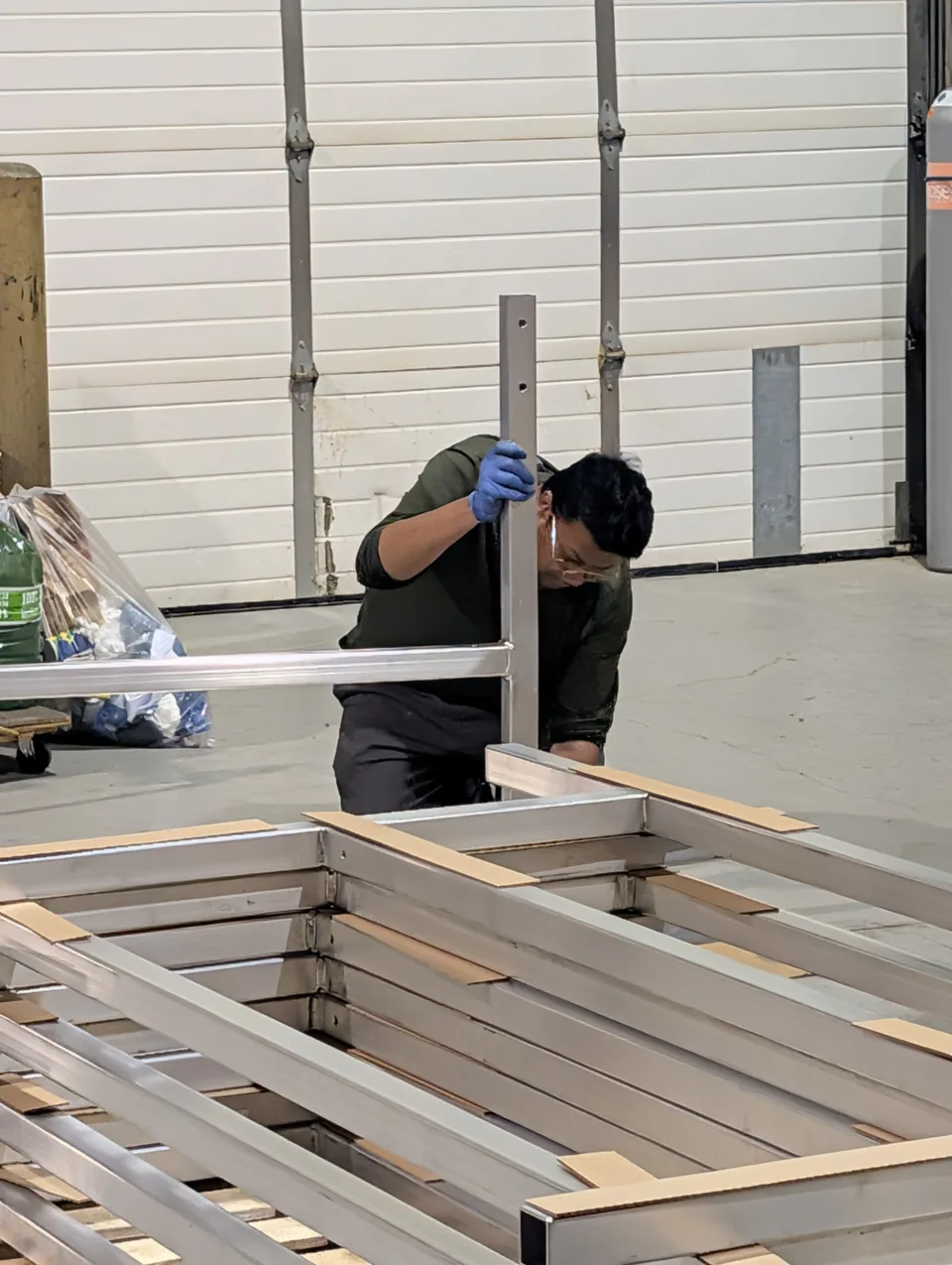 RWS technician assembling aluminum handrail frames in the shop